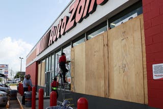 2024年7月3日、メキシコのメリダで、ハリケーン・ベリルの被害を避けるために店舗を閉める従業員たち